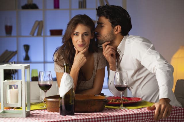 Romantic couple having dinner at home.