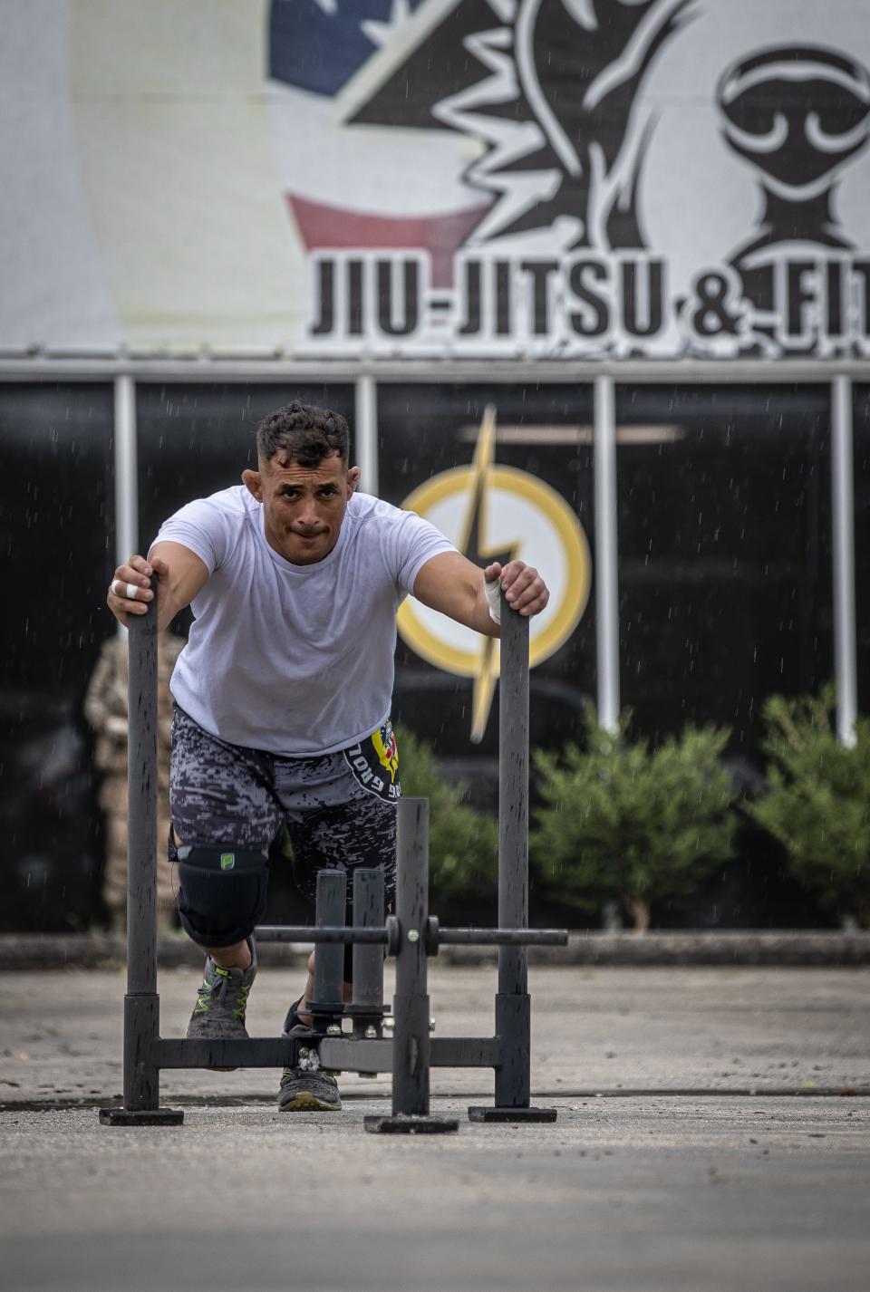 Alabama National Guard Pfc. Elioenai Campos pushes a resistance sled during a strength and conditioning training session in Columbiana, Alabama, June 10, 2022. Campos is part of the United States national jiu-jitsu team set to compete for international honors at the World Games in Birmingham.