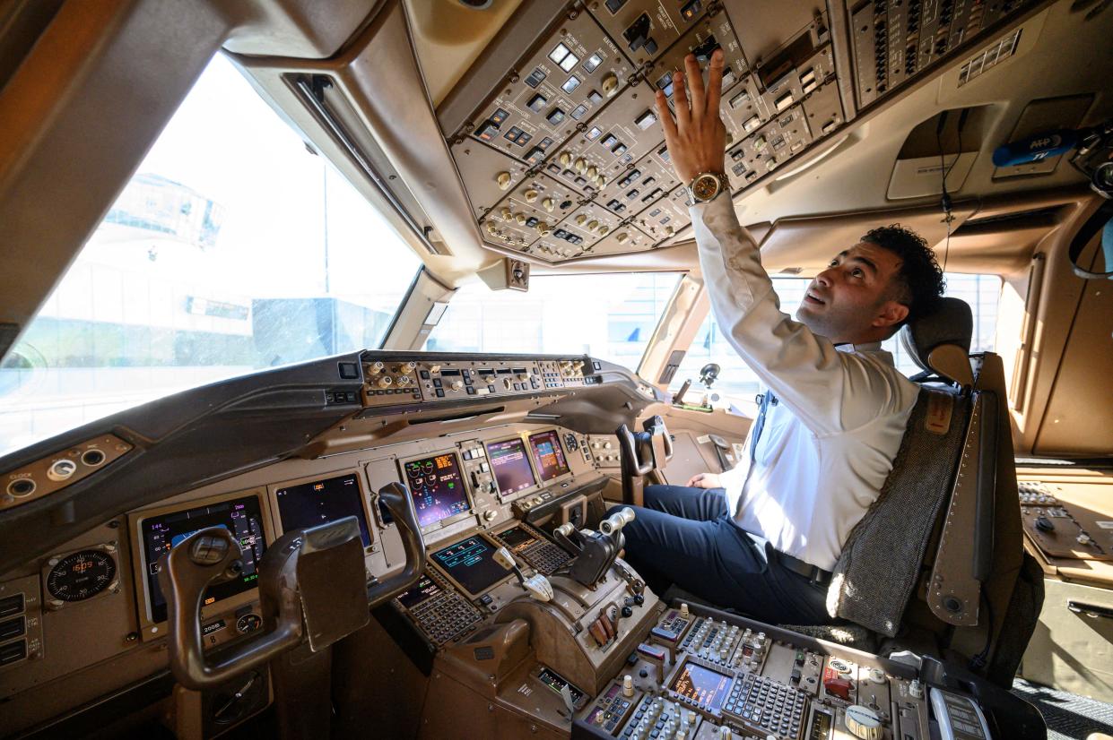 Pilot Omar Morsi checks controls in the cockpit of a United Airlines Boeing 777 aircraft at Newark Liberty International Airport in Newark, New Jersey, on March 9, 2023. - Airlines and unions disagree on many aspects relating to today's tight labor market, but concur on at least one thing: the need to diversify the pilot workforce pool. (Photo by Ed JONES / AFP) (Photo by ED JONES/AFP via Getty Images)