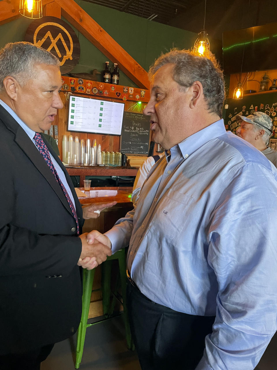 Republican presidential candidate former New Jersey Gov. Chris Christie courts voters on Tuesday, Sept. 12, 2023, at a brewery in Goffstown, N.H. He's one of the few GOP candidates focusing on the Granite State this year. Most of the Republican presidential field is focusing their money, time and attention on Iowa. (AP Photo/Steve Peoples)