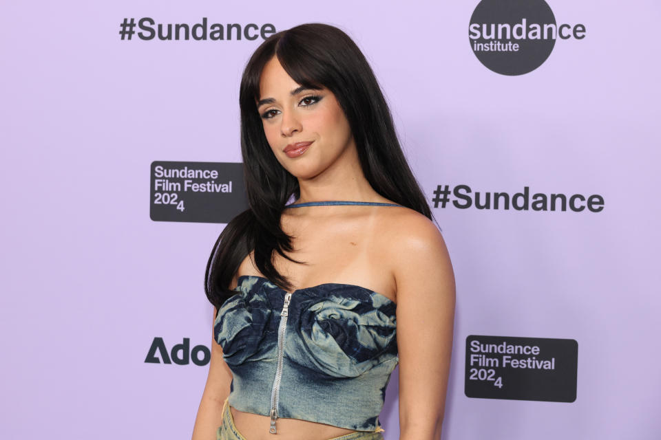 Camila Cabello at the 2024 Sundance Film Festival, wearing a strapless denim-style top with a zipper