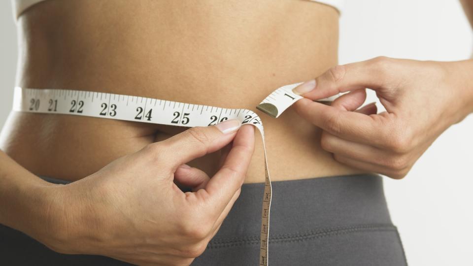 Woman measures weight circumference
