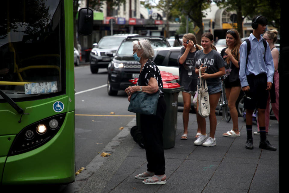 People wear face masks on public transport in Auckland.