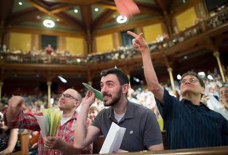 Alex Frieden (C), along with fellow audience members, flies a paper airplane at the 25th First Annual Ig Nobel Prizes awards ceremony at Harvard University in Cambridge, Massachusetts September 17, 2015. REUTERS/Gretchen Ertl