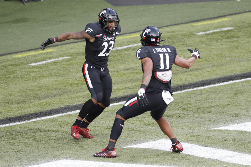 Cincinnati running back Gerrid Doaks, left, celebrates his touchdown against Army with teammate Leonard Taylor during the second half of an NCAA college football game Saturday, Sept. 26, 2020, in Cincinnati, Ohio. Cincinnati beat Army 24-10. (AP Photo/Jay LaPrete)