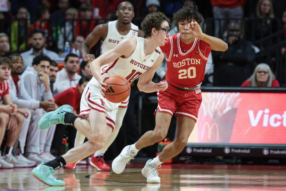 Nov 10, 2023; Piscataway, New Jersey, USA; Rutgers Scarlet Knights guard Gavin Griffiths (10) dribbles as Boston University Terriers guard Michael McNair (20) defends during the first half at Jersey Mike's Arena. Mandatory Credit: Vincent Carchietta-USA TODAY Sports