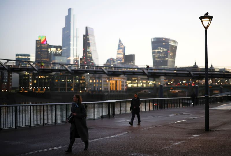 The financial district can be seen as a people walk along the South bank, amid the coronavirus disease (COVID-19) outbreak, in London