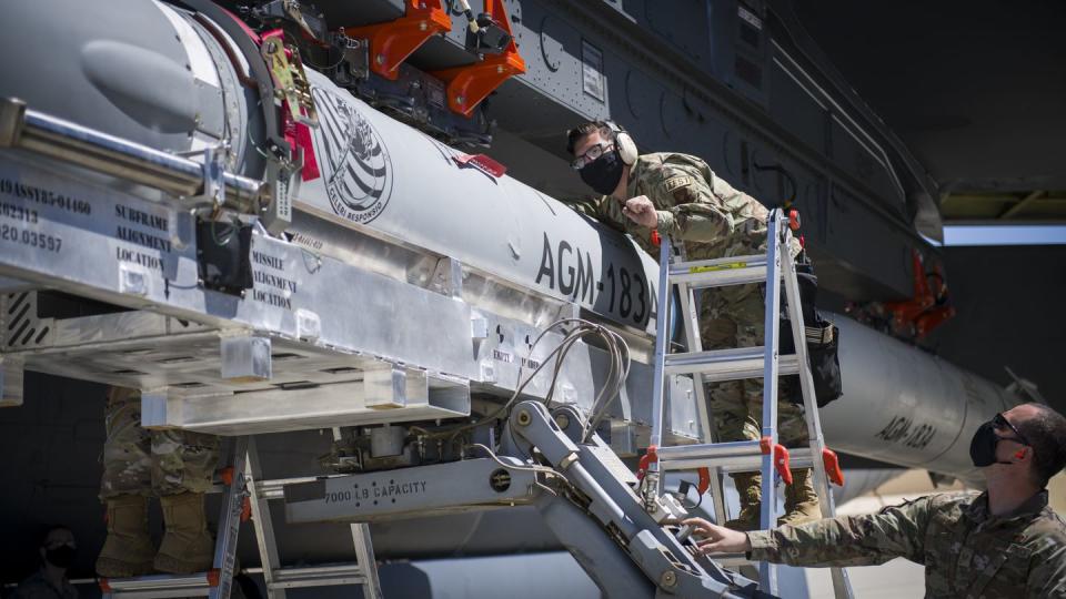 An airman helps line up an AGM-183A as it is loaded under the wing of a B-52H Stratofortress at Edwards Air Force Base, Calif. (Giancarlo Casem/U.S. Air Force)