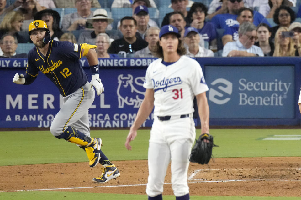 Milwaukee Brewers' Rhys Hoskins, left, heads to first for a grand slam as Los Angeles Dodgers starting pitcher Tyler Glasnow watches during the fourth inning of a baseball game Friday, July 5, 2024, in Los Angeles. (AP Photo/Mark J. Terrill)