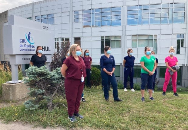 Nurses across Quebec organized sit-ins near their workplaces Wednesday to protest forced overtime and working conditions that have cause many to burn out during the pandemic. The province announced Thursday it will offer nurses financial bonuses to address the staffing crisis.  (Kassandra Nadeau-Lamarche/Radio-Canada - image credit)