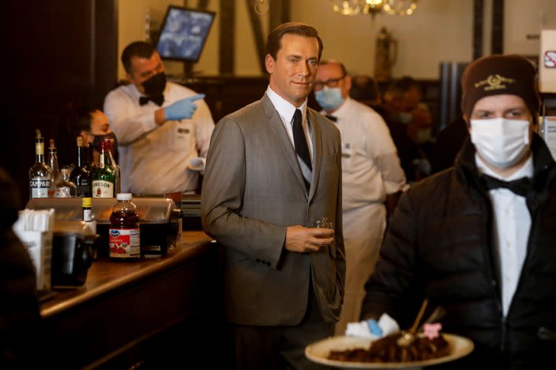 Madame Tussauds's wax figure of Jon Hamm stands at the bar at Peter Luger Steak House in Brooklyn, New York