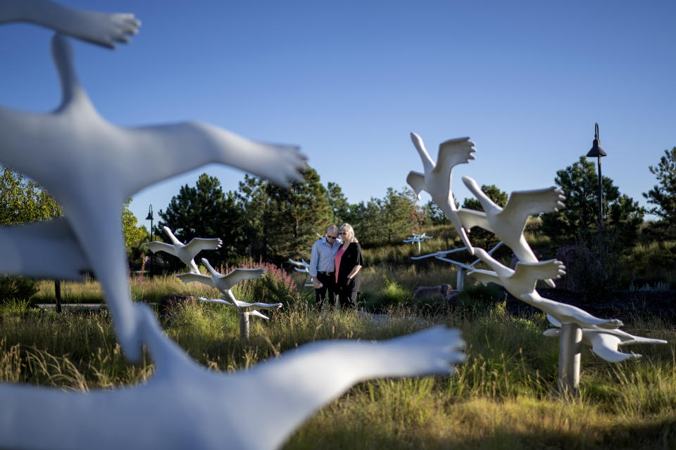 On Tuesday, Sept. 5, 2023, Lonnie Phillips, left, and his wife, Sandy, stand among the crane sculptures ascending to the sky as part of the memorial garden in Aurora, Colo., honoring the victims of the 2012 mass shooting at an Aurora movie theater, including Sandy’s daughter, Jessica Ghawi. “You can’t help but come here and ask why?” said Sandy Phillips. “I get my strength from him (Lonnie) and from Jess. It’s a fight every day.” (AP Photo/David Goldman)