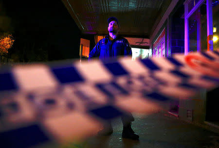 FILE PHOTO - A policeman stands on a street that has been blocked to the public after Australian counter-terrorism police arrested four people in raids late on Saturday across several Sydney suburbs in Australia, July 29, 2017. REUTERS/David Gray/File photo