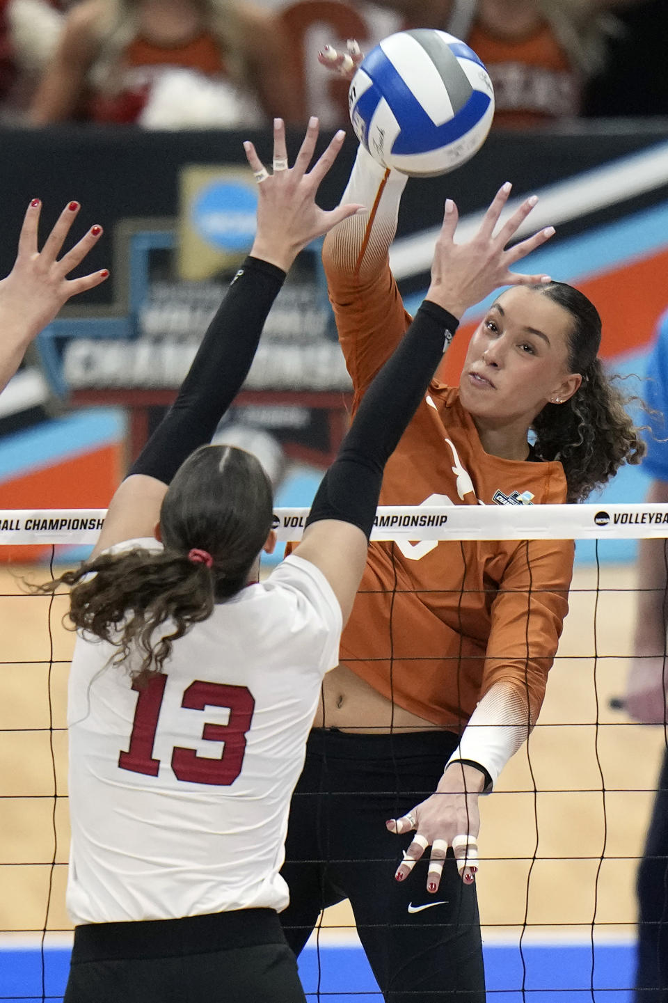 Texas's Madisen Skinner (6) spikes the ball past Nebraska's Merritt Beason (13) during the championship match in the NCAA Division I women's college volleyball tournament Sunday, Dec. 17, 2023, in Tampa, Fla. (AP Photo/Chris O'Meara)