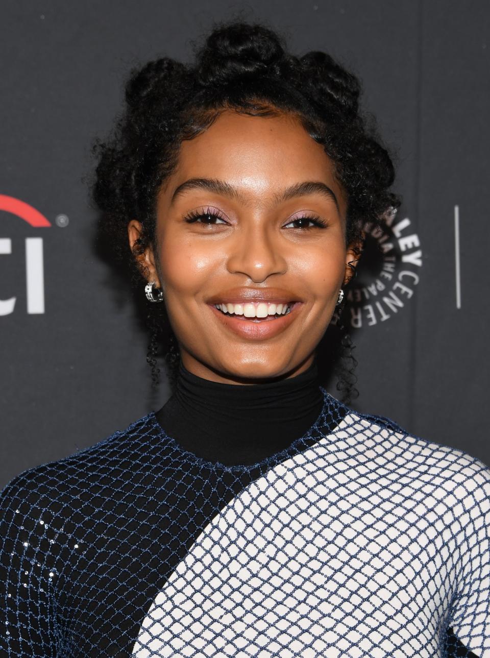 Yara Shahidi smiles at an event