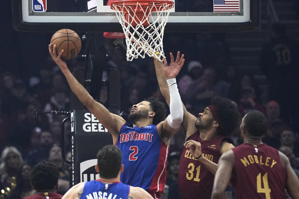 Detroit Pistons guard Cade Cunningham (2) shoots in front of Cleveland Cavaliers center Jarrett Allen (31) in the first half of an NBA basketball game, Wednesday, Jan. 31, 2024, in Cleveland. (AP Photo/Sue Ogrocki)