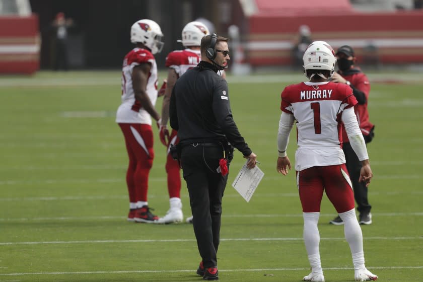 Arizona Cardinals head coach Kliff Kingsbury talks with quarterback Kyler Murray (1).