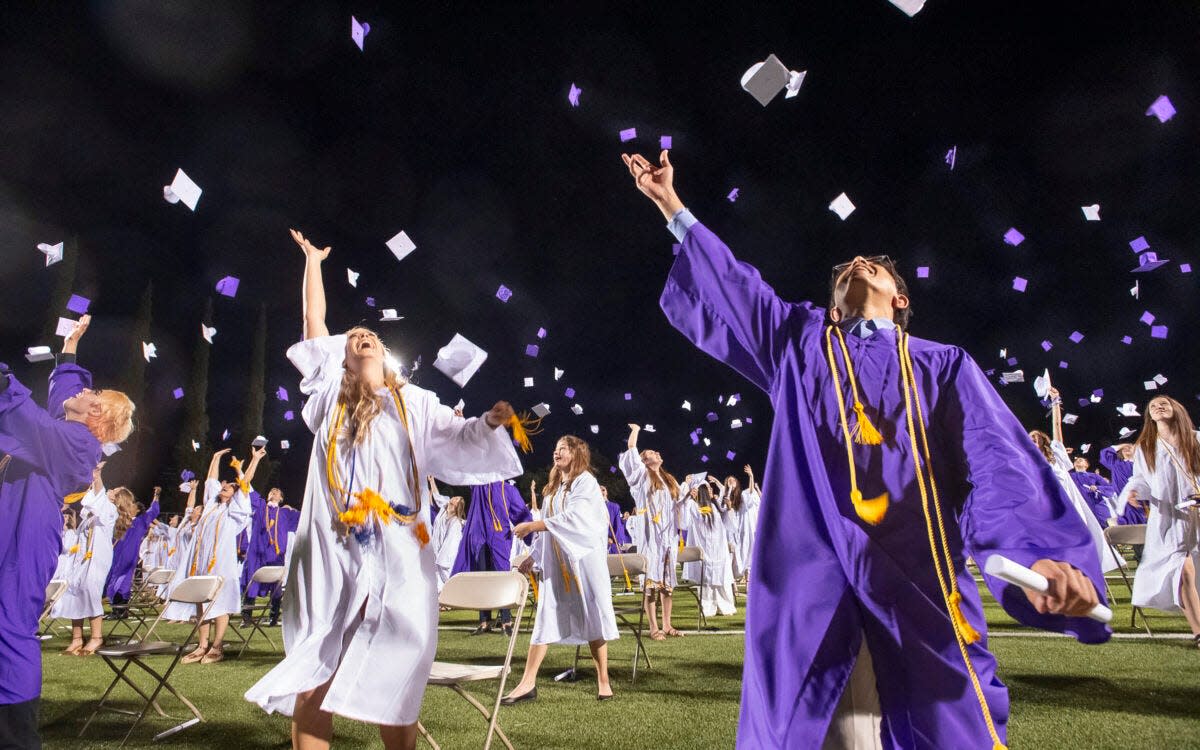 Shasta High School graduates fling their mortarboards into the air at the conclusion of the graduation ceremony at Shasta High School in Redding on June 4, 2021.