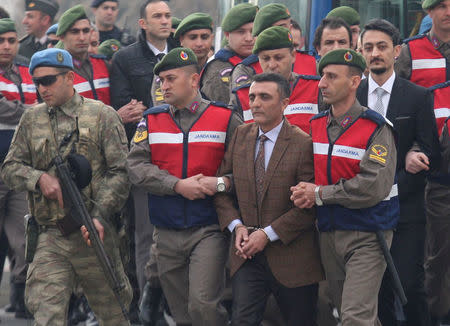 Zekeriya Kuzu, one of the main suspects accused of attempting to assassinate Turkish President Tayyip Erdogan on the night of the failed last year's July 15 coup, is escorted by Turkish gendarmes as he arrives for the first hearing of the trial in Mugla, Turkey, February 20, 2017. REUTERS/Kenan Gurbuz