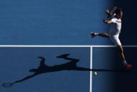 Tennis - Australian Open - Rod Laver Arena, Melbourne, Australia, January 22, 2018. Roger Federer of Switzerland hits a shot against Marton Fucsovics of Hungary. REUTERS/Edgar Su