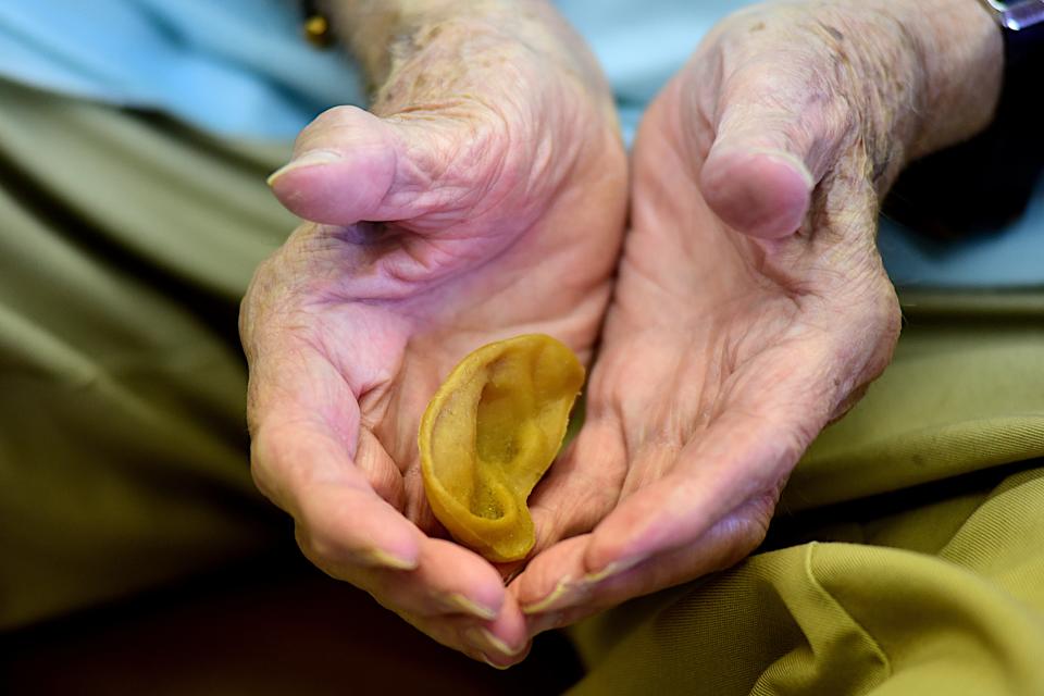 Bob Keller holds the fake ear he's used to prank youngsters for parts of seven decades at Keller's Barbershop in Bucyrus.