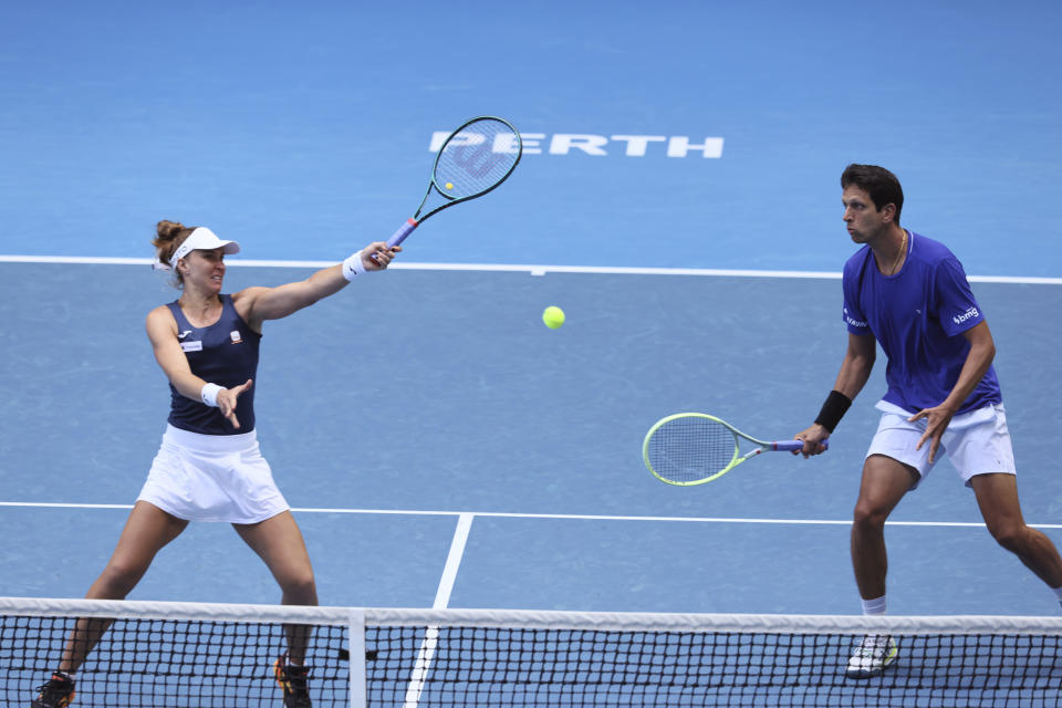 Beatriz Haddad Maia of Brazil hits a shot watched by partner Marcelo Melo during their mixed doubles match against Sara Sorribes Tormo and Alejandro Davidovich Fokina of Spain at the United Cup tennis tournament in Perth, Australia, Friday, Dec. 29, 2023. (AP Photo/Trevor Collens)