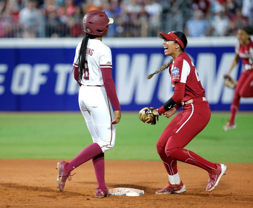 Oklahoma's Tiare Jennings (23) celebrates tagging out Florida State's Kalei Harding (8) at second base after she tried double in the sixth inning during the first game of the Women's College World Championship Series between the Oklahoma Sooners at USA Softball Hall of Fame Stadium in  in Oklahoma City, Wednesday, June, 7, 2023.