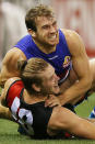 Stewart Crameri and Michael Hurley get physical in the clash between the Bulldogs and the Bombers.