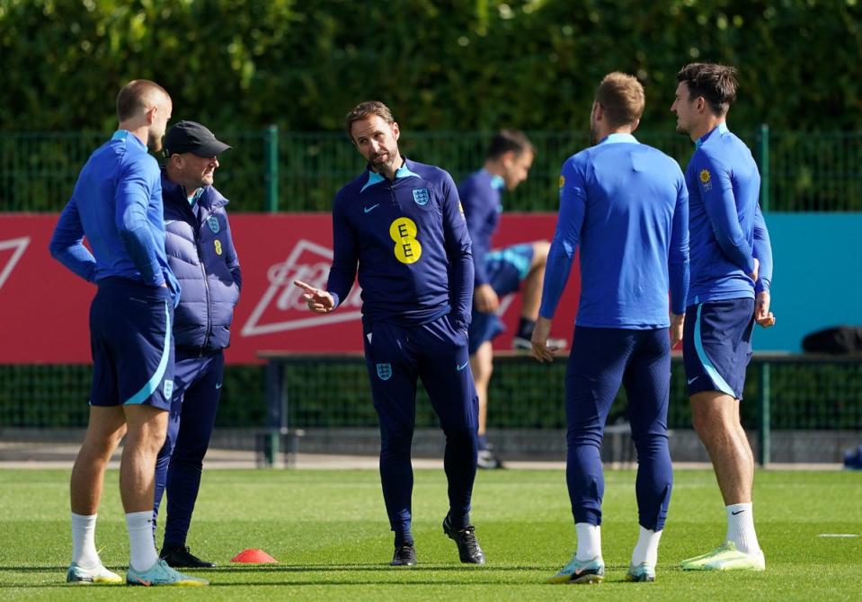 Gareth Southgate speaks to Eric Dier and Harry Maguire (PA)