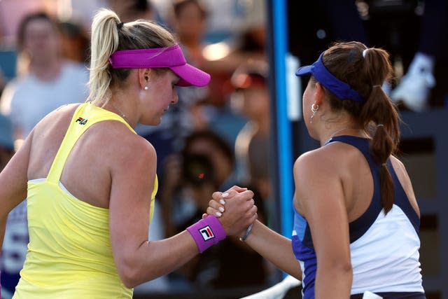 Ukraine's Kateryna Baindl, left, shakes hands with Russian opponent Kamilla Rakhimova