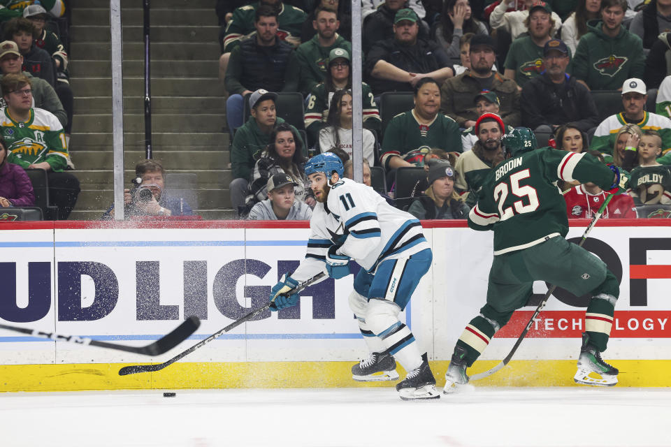 San Jose Sharks center Luke Kunin (11) moves the puck against the Minnesota Wild during the first period of an NHL hockey game, Sunday, March 3, 2024, in St. Paul, Minn. (AP Photo/Stacy Bengs)