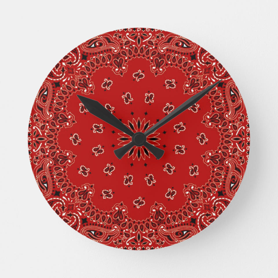 This image released by Zazzle shows a wall clock that features a bandana print. Zazzle has melamine plates, ceramic mugs, and ceiling and table lamps featuring the bandana paisley motif, in vibrant hues of red, blue, purple, turquoise, green or gold. (Zazzle via AP)