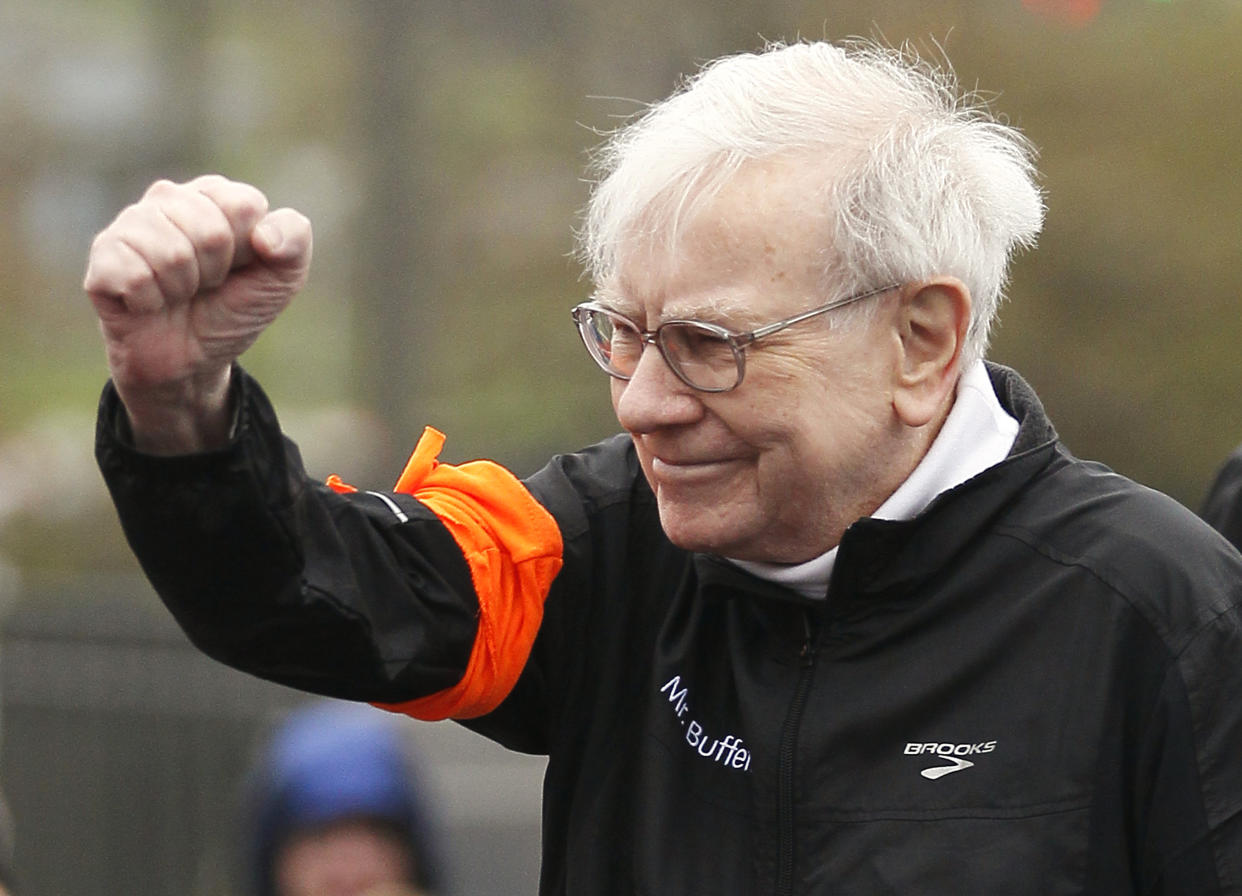 Berkshire Hathaway chairman Warren Buffett gestures at the start of a 5km race sponsored by Brooks Sports Inc., a Berkshire-owned company, in Omaha May 5, 2013, a day after the company's annual meeting. Buffett at the meeting on May 4, 2013 gave the most extensive comments to date about the future of Berkshire Hathaway Inc after he is gone, saying he still expects the conglomerate to be a partner of choice for distressed companies.  REUTERS/Rick Wilking (UNITED STATES - Tags: BUSINESS SPORT ATHLETICS)