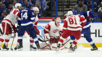 Detroit Red Wings goaltender Ville Husso (35) makes a save on a shot by Tampa Bay Lightning left wing Nicholas Paul (20) during the third period of an NHL hockey game Tuesday, Dec. 6, 2022, in Tampa, Fla. (AP Photo/Chris O'Meara)