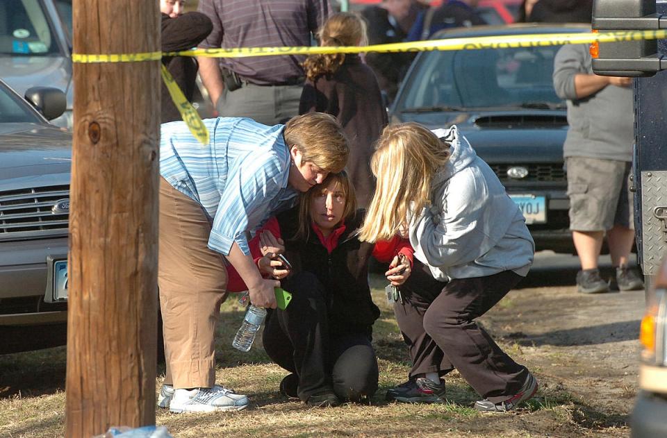 People are comforted near Sandy Hook Elementary School, Dec. 14, 2012 in Newtown, Conn (AP)