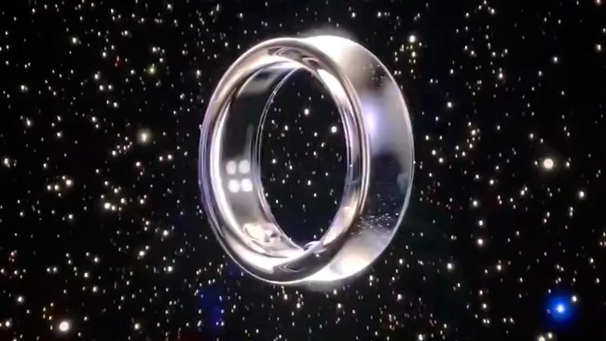  The Samsung Galaxy Ring in silver against an outer space background with stars. 