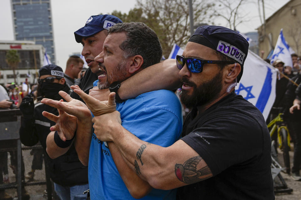 Israeli police officers arrest an Israeli protester against plans by Prime Minister Benjamin Netanyahu's government to overhaul the judicial system in Tel Aviv, Israel, Thursday, March 23, 2023. (AP Photo/Ohad Zwigenberg)