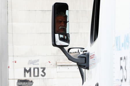 A truck driver waits in a long queue for border customs control to cross into the U.S., at the Otay border crossing in Tijuana, Mexico April 4, 2019. REUTERS/Carlos Jasso