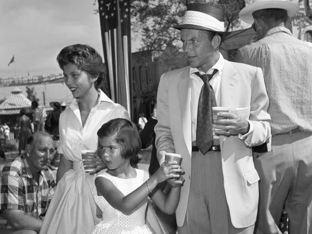 <p>Screen Archives/Getty</p> Frank Sinatra with his daughters Nancy and Tina, circa 1956.