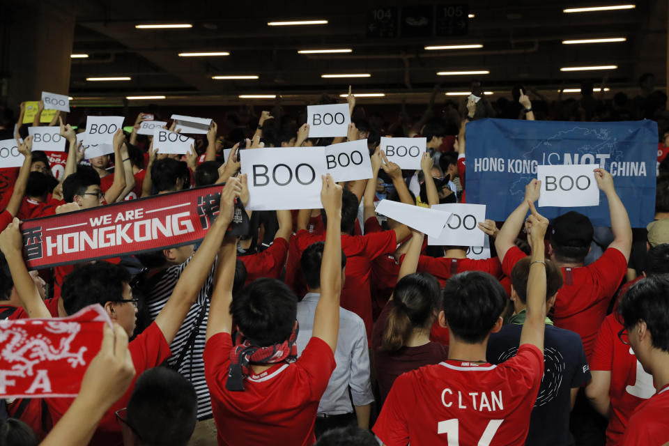 Hong Kong soccer fans turn their back and boo the Chinese national anthem as they chant "Hong Kong is not China" during the FIFA World Cup Qatar 2022 and AFC Asian Cup 2023 Preliminary Joint Qualification Round 2 soccer match between Hong Kong and Iran, in Hong Kong, Tuesday, Sept. 10, 2019. The crowd broke out into "Glory to Hong Kong," a song reflecting their campaign for more democratic freedoms in the semi-autonomous Chinese territory. (AP Photo/Kin Cheung)