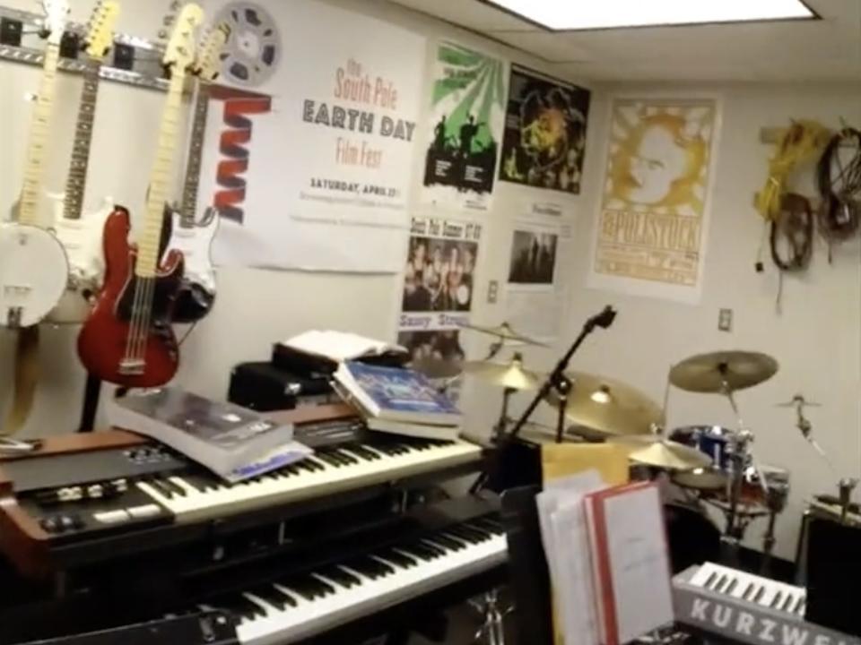 The music room at the Amundsen-Scott South Pole station is shown, filed with instruments like guitars, keyboard and drums.