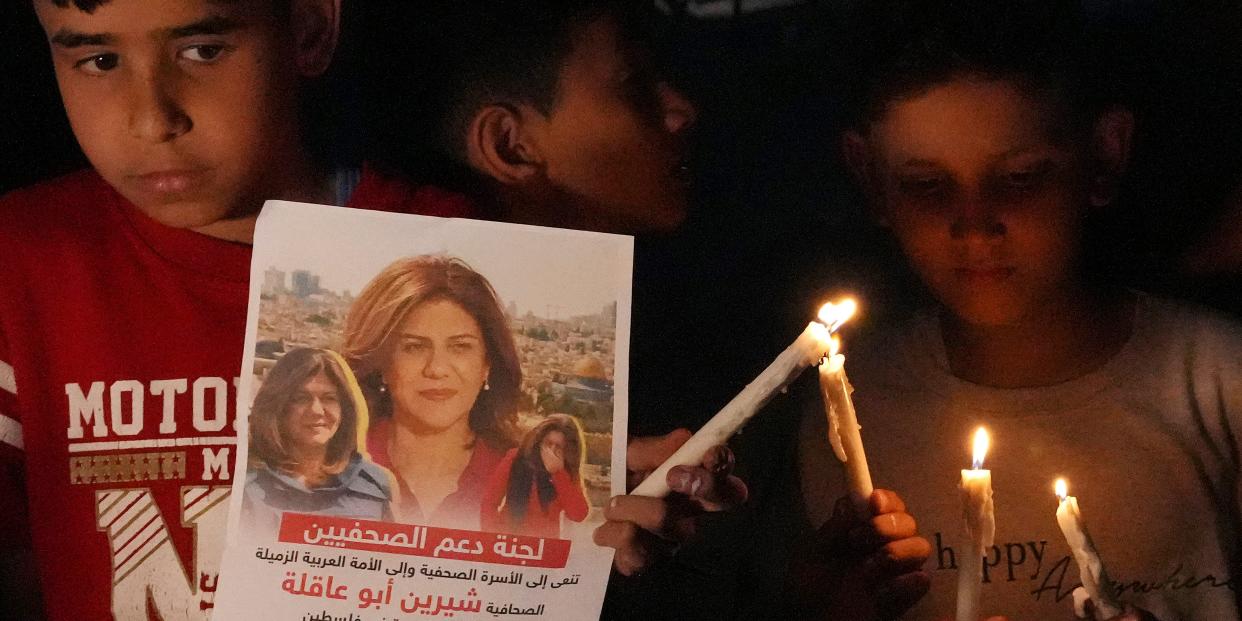 Palestinian children carry light candles and pictures of slain Al Jazeera journalist Shireen Abu Akleh, to condemn her killing, in front of the office of Al Jazeera network, in Gaza City, Wednesday, May 11, 2022. Abu Akleh was shot and killed while covering an Israeli raid in the occupied West Bank town of Jenin early Wednesday.