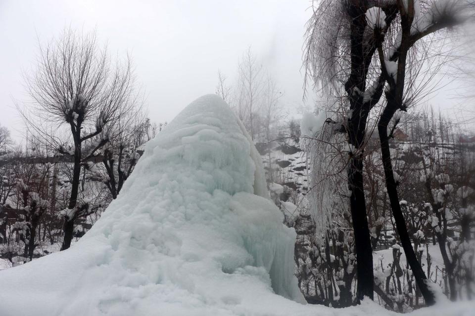 As the night temperature continues to fall in Kashmir, a small leakage in a water pipe leads to a formation of a mound of icicles.