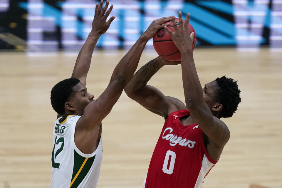 Houston guard Marcus Sasser (0) is fouled by Baylor guard Jared Butler (12) during the second half of a men's Final Four NCAA college basketball tournament semifinal game, Saturday, April 3, 2021, at Lucas Oil Stadium in Indianapolis. (AP Photo/Michael Conroy)