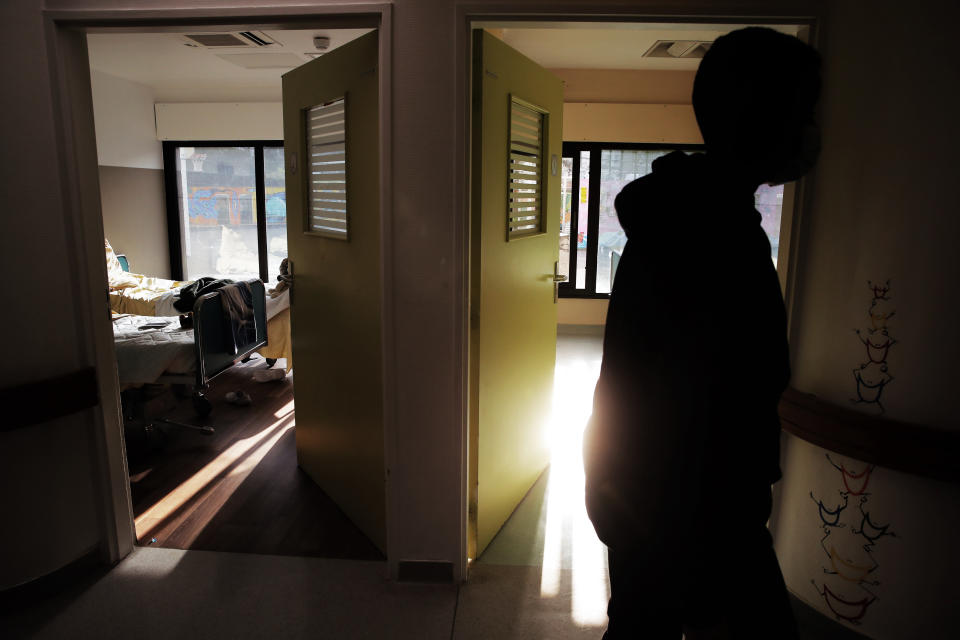 A child walks past rooms in the pediatric unit of the Robert Debre hospital, in Paris, France, Tuesday, March 2, 2021. A year into the coronavirus pandemic, increasing numbers of children are coming apart at the seams, their mental health shredded by the traumas of deaths, sickness and job losses in their families, the disruptions of lockdowns and curfews, and a deluge of anxieties poisoning their fragile young minds. (AP Photo/Christophe Ena)