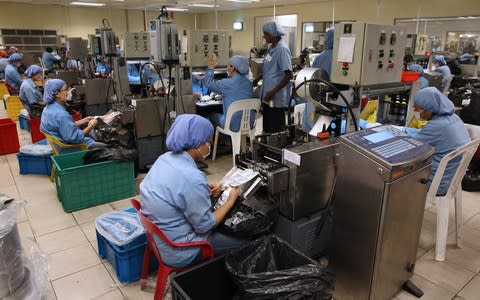 Workers labour on the production line of Karex Industries factory in Pontian Besar, Johor, Malaysia - Credit: Goh Seng Chong /Bloomberg