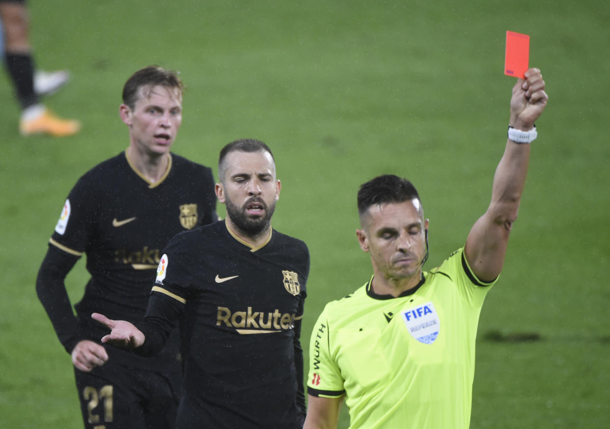 Barcelona's Spanish defender Jordi Alba (2L) reacts to Spanish referee Carlos del Cerro presenting a red card to Barcelona's French defender Clement Lenglet (out of frame) during the Spanish league football match RC Celta de Vigo against FC Barcelona at the Balaidos stadium in Vigo on October 1, 2020. (Photo by MIGUEL RIOPA / AFP) (Photo by MIGUEL RIOPA/AFP via Getty Images)