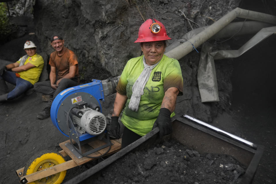 Emerald miner Yaneth Forero, 52, stands at the entrance to an informal mine near the town of Coscuez, Colombia, Thursday, Feb. 29, 2024. “There are months or years in which I don’t even make $250” from the emerald mines," said Forero, “But we continue to struggle here for the dream of having a home with tiles on the floors, a place that smells good and where no one can kick me out.” (AP Photo/Fernando Vergara)