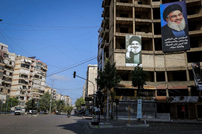 Pictures of killed pro-Iranian Hezbollah chief Hassan Nasrallah are hung on a building in an almost deserted area in Beirut southern suburb. Marwan Naamani/dpa