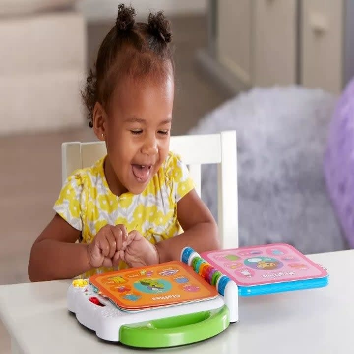 Child model playing with plastic word book